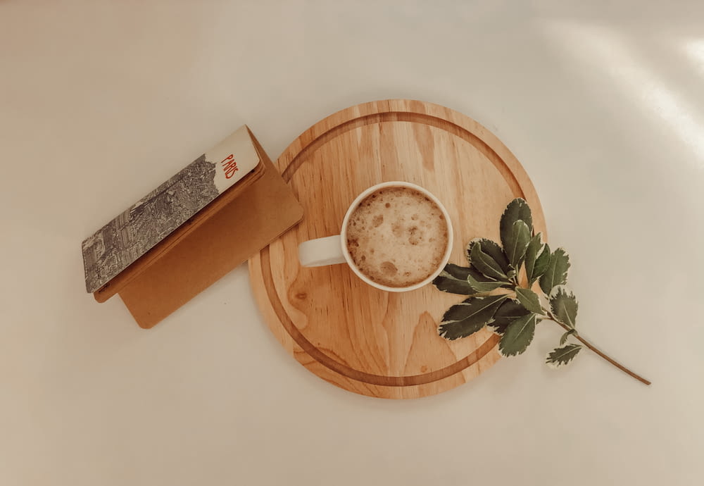 white ceramic mug on brown wooden round tray