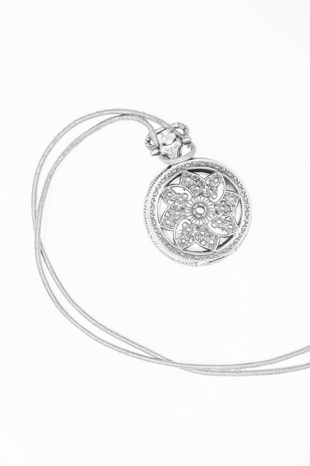 silver round pendant with white background