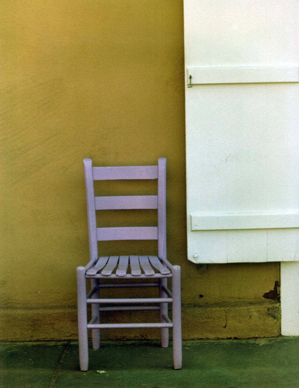 white wooden chair beside white wall