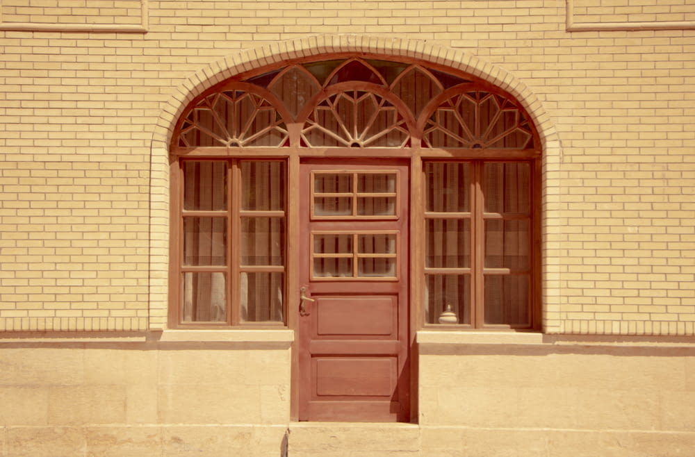 brown wooden door on brown concrete building