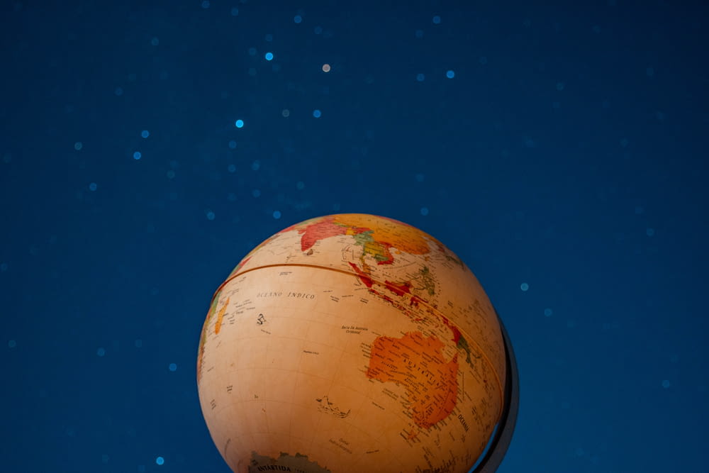 brown and beige globe with blue background