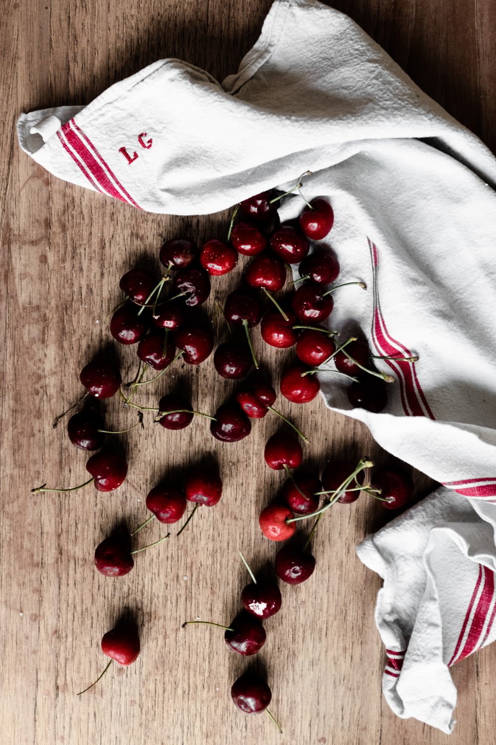 red cherries on white textile