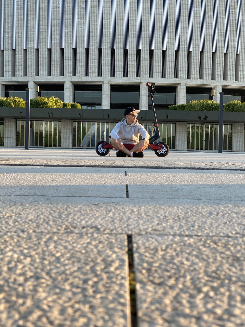 man in black shirt riding on black and white bicycle on gray concrete road during daytime