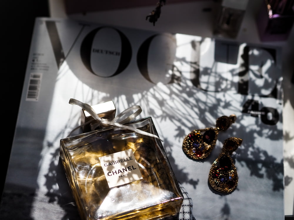 gold and silver baubles on clear glass bottle