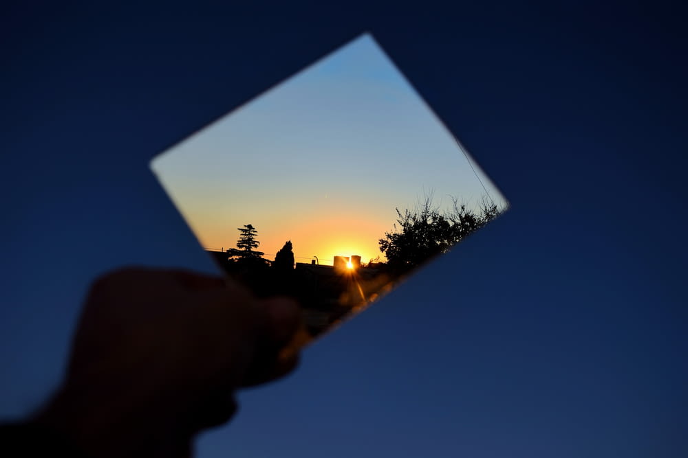 person holding photo of sun