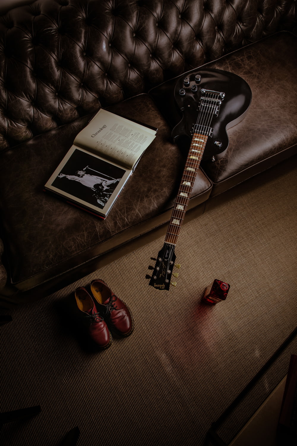 black and white stratocaster electric guitar beside black and white book