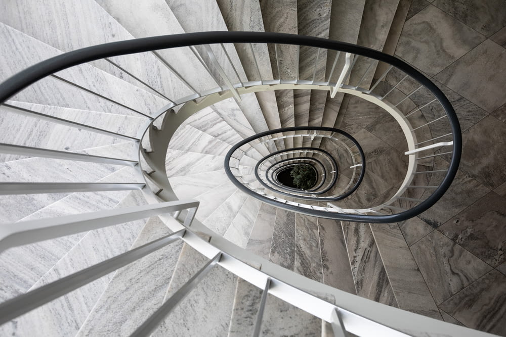 white spiral staircase with gray metal railings