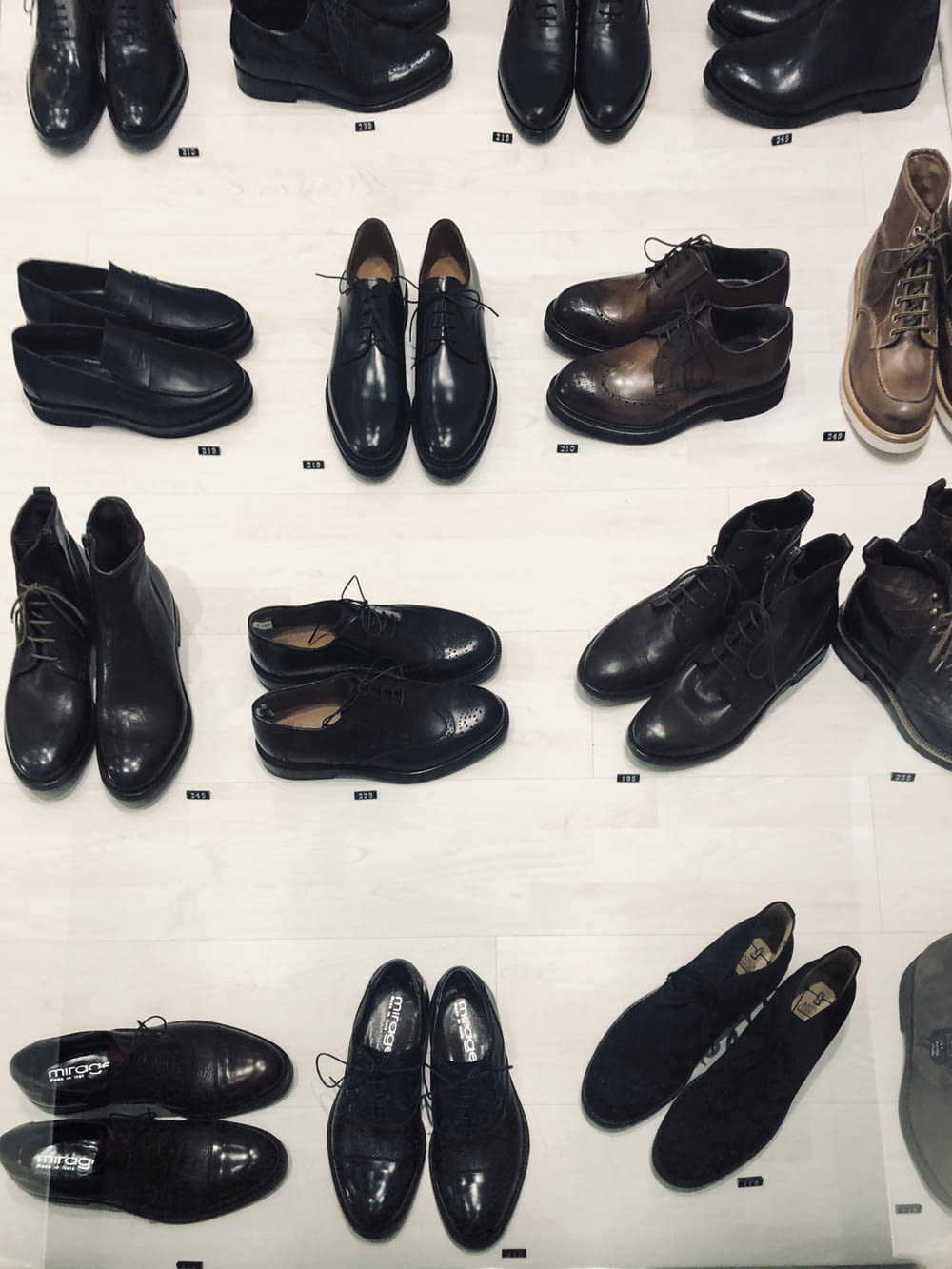 black leather dress shoes on white floor tiles