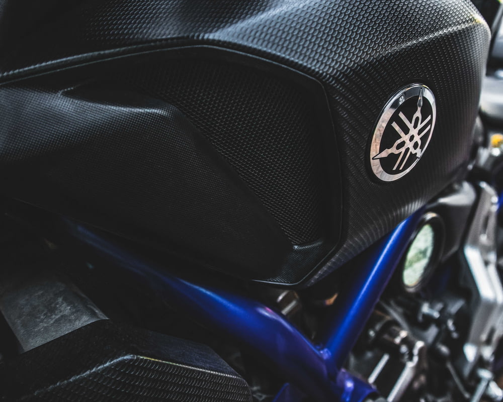 black and blue motorcycle in close up photography
