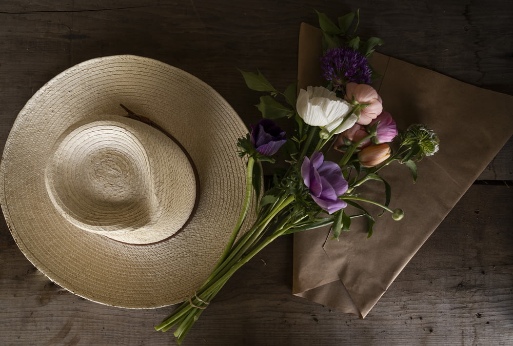 brown cowboy hat beside purple flower