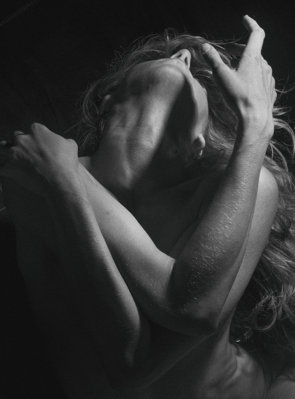grayscale photo of woman covering face with both hands