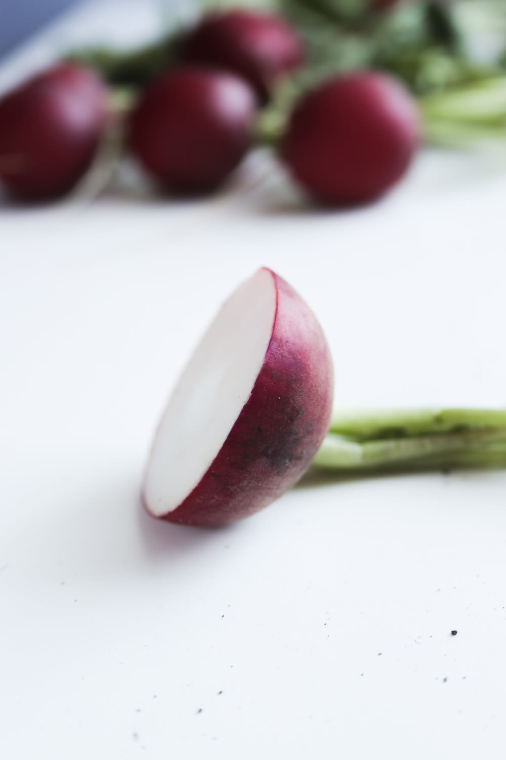red and white fruit on white surface