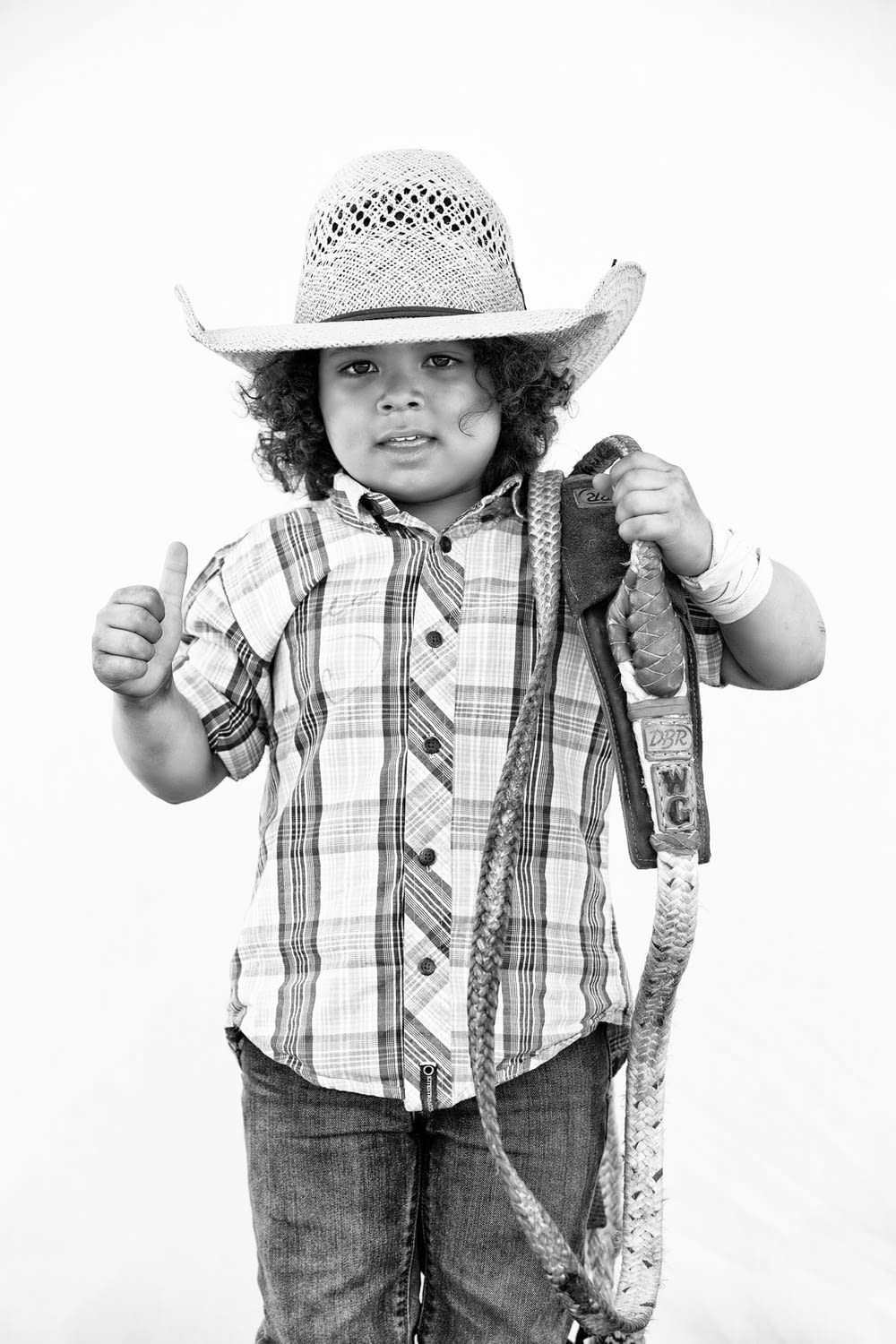 grayscale photo of boy wearing cowboy hat