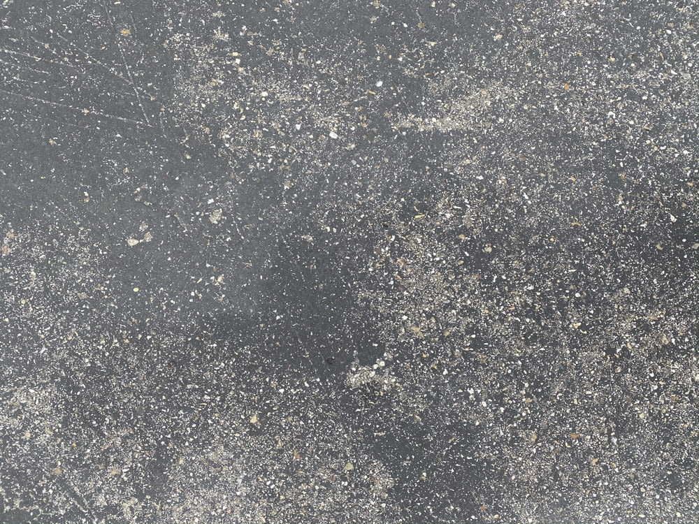 white and black stone on gray concrete floor