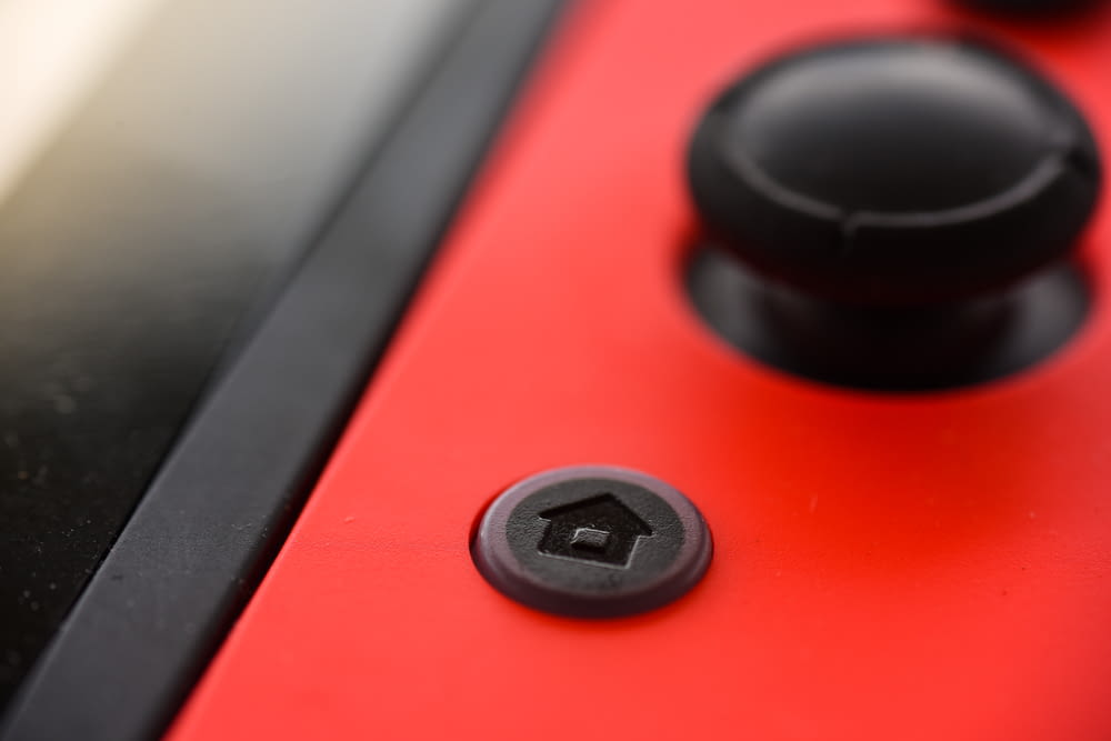 black round button on red and black board