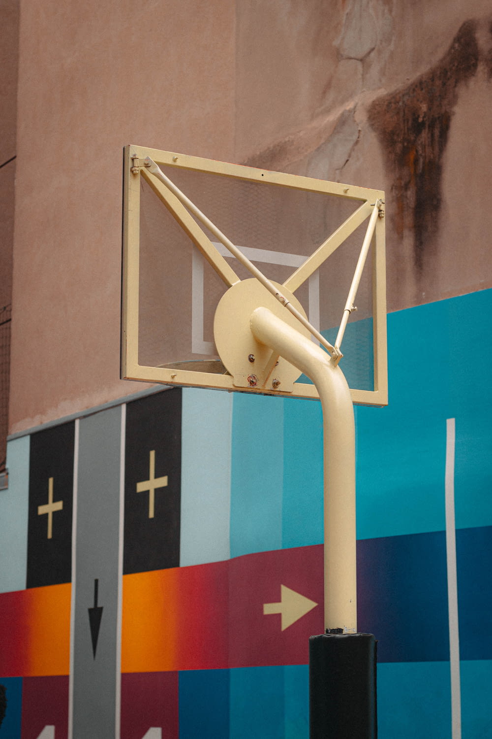 a basketball hoop in front of a colorful wall