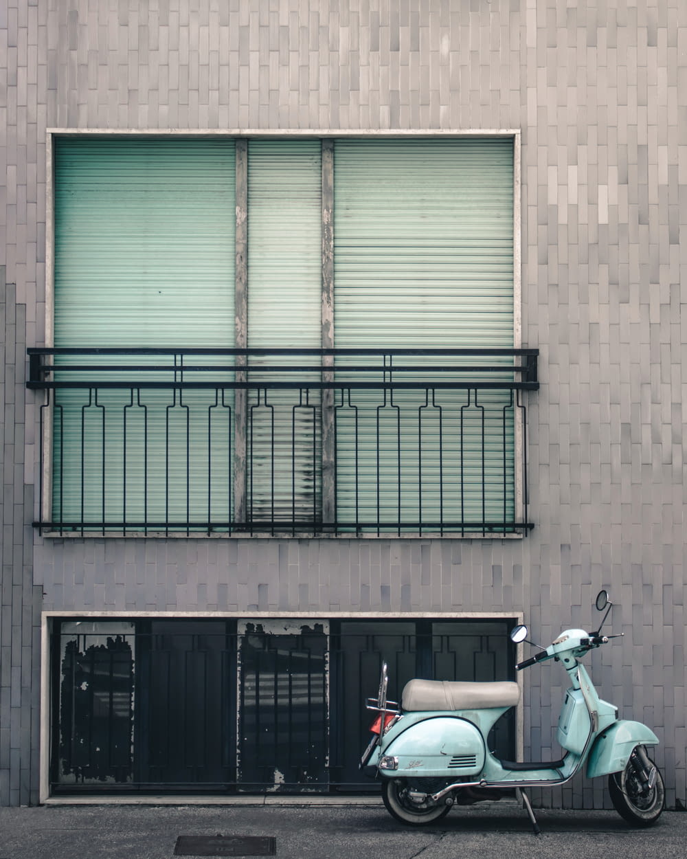 white and black motorcycle parked beside brown building