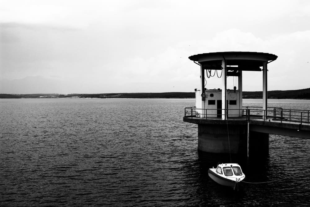 grayscale photo of a boat on a body of water