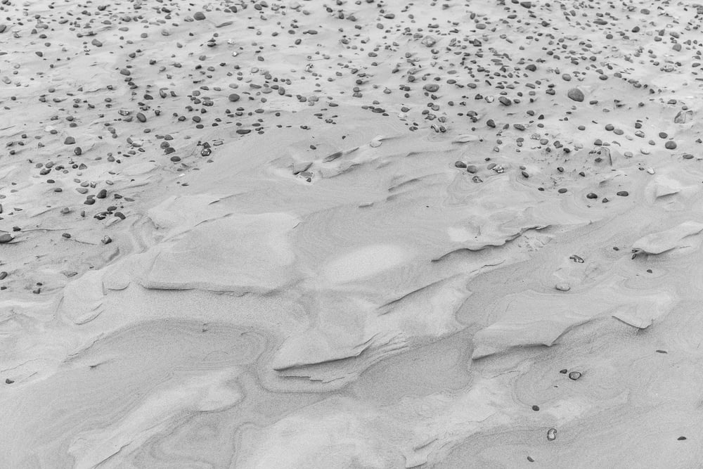 gray sand with water during daytime