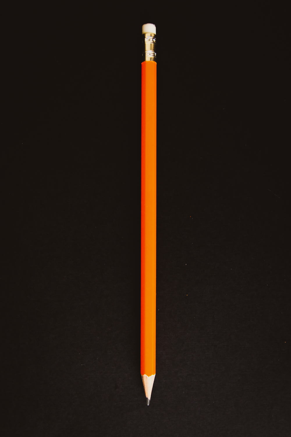 orange pencil on black textile
