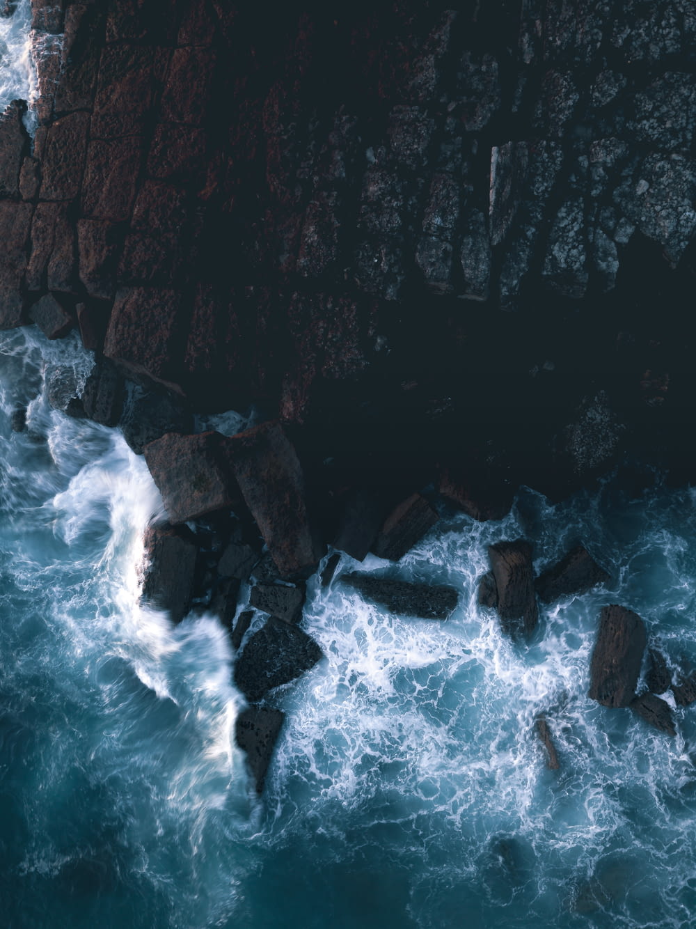water waves hitting rocks during daytime