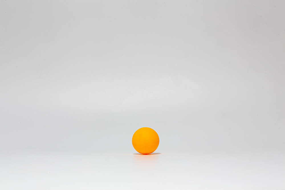 yellow ball on white surface