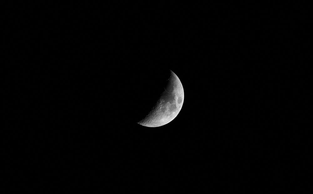 grayscale photo of half moon
