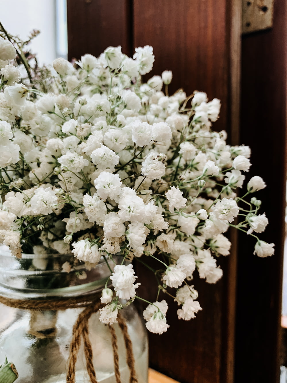 white flowers on clear glass vase