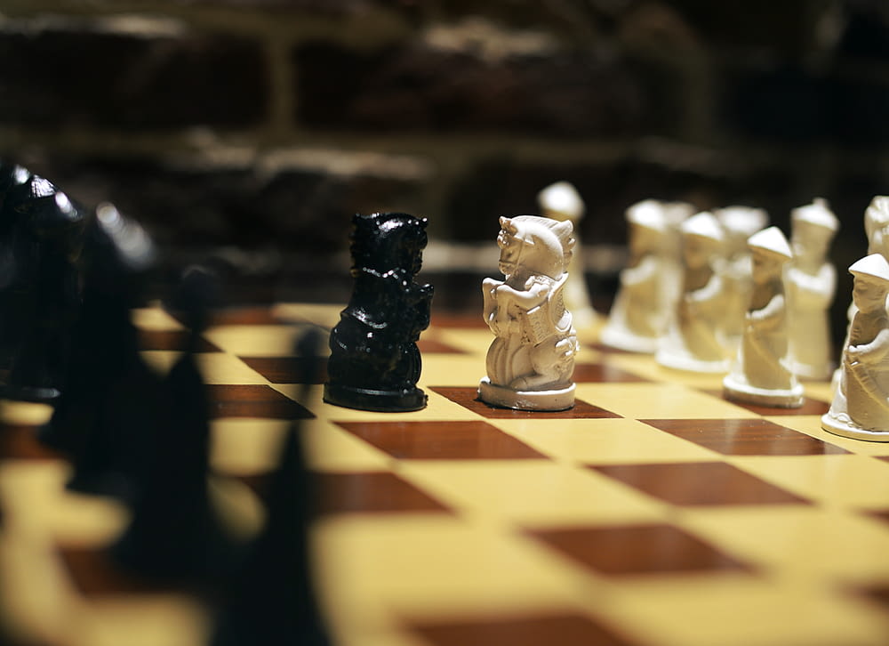 a group of chess pieces sitting on top of a chess board