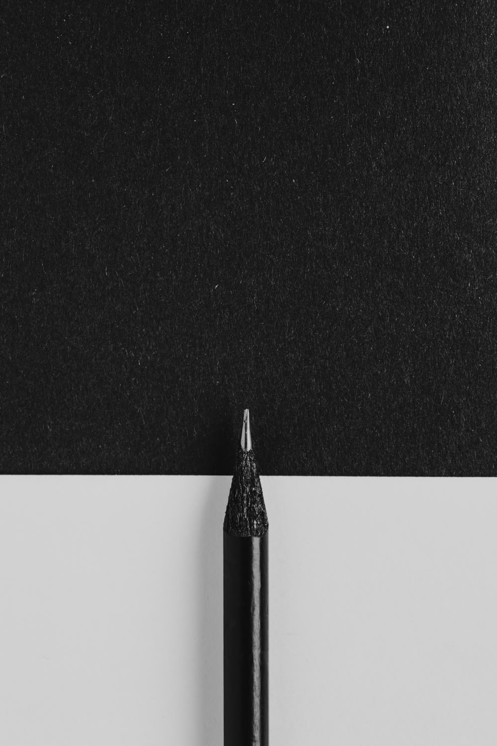 a black pen sitting on top of a piece of paper