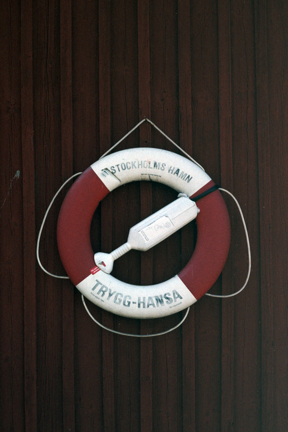 a life preserver hanging on a wooden wall