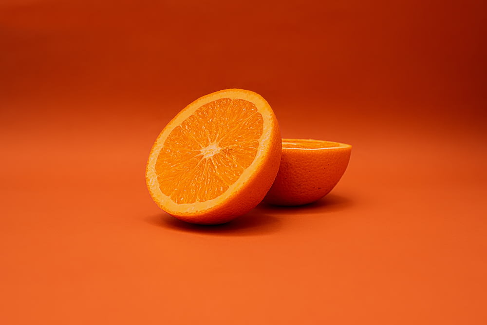 sliced lemon on orange surface