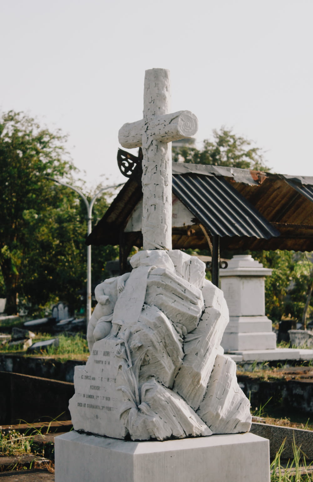 white concrete statue of man holding cross