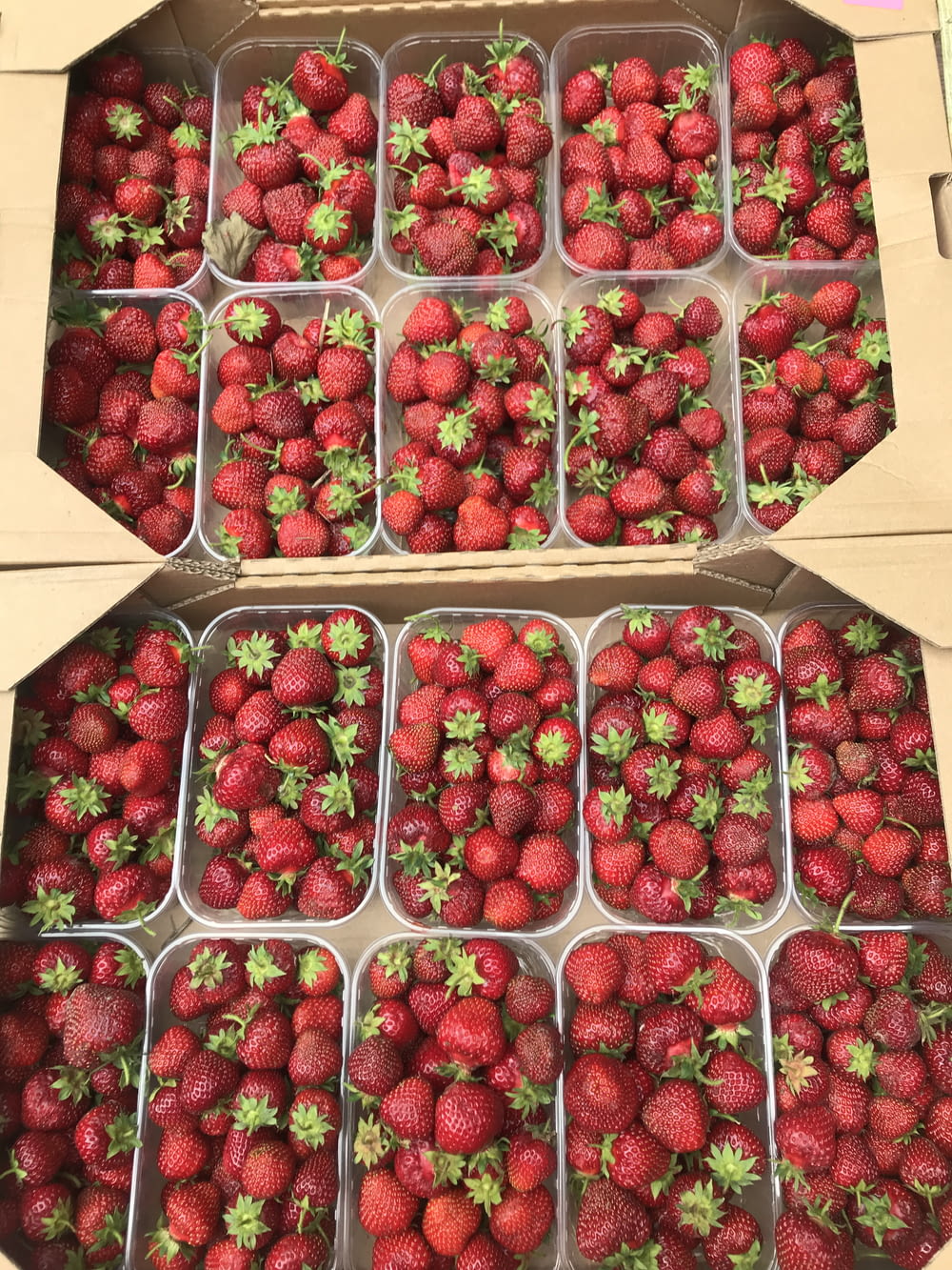 red strawberries in brown cardboard box