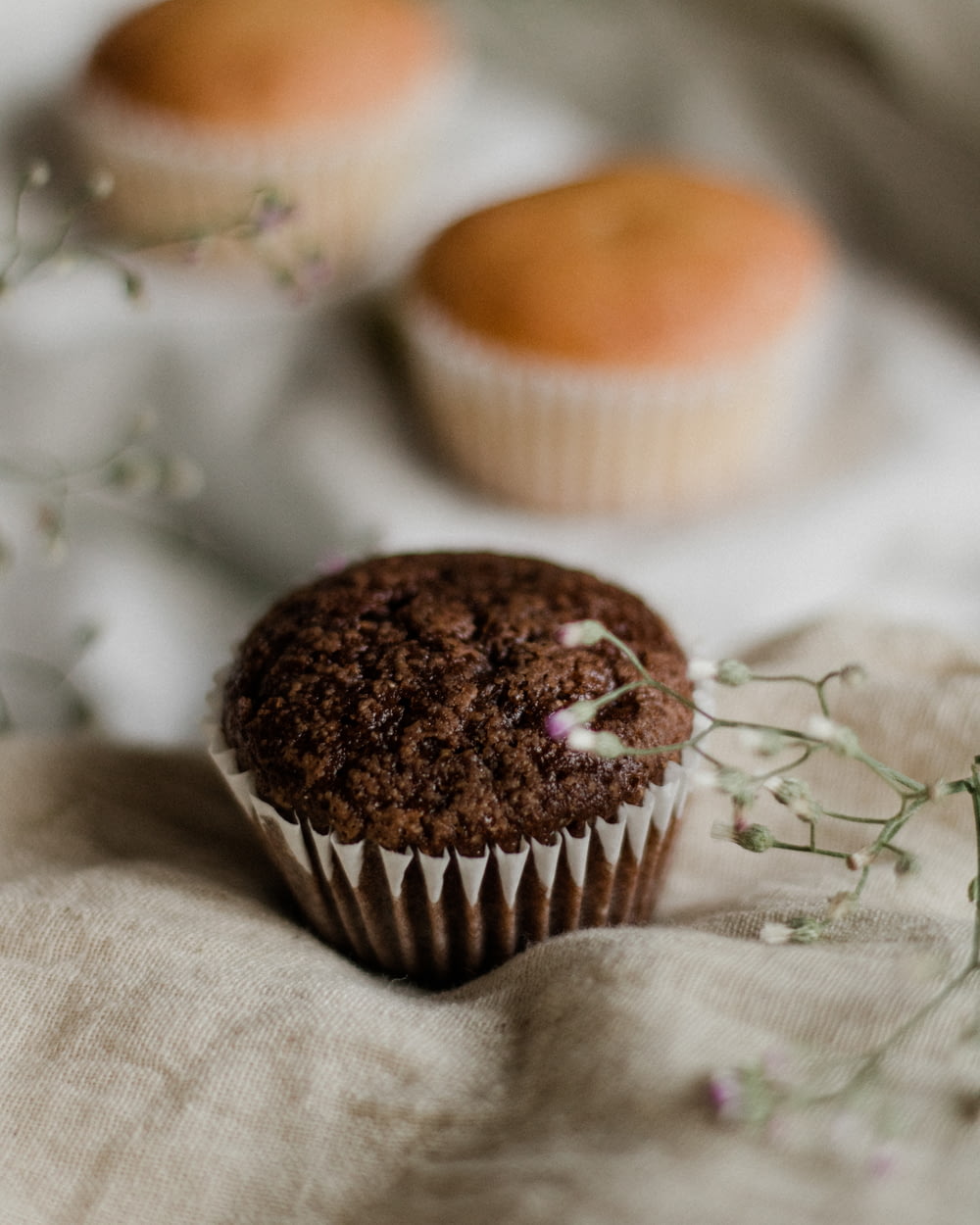 brown cupcake on white textile