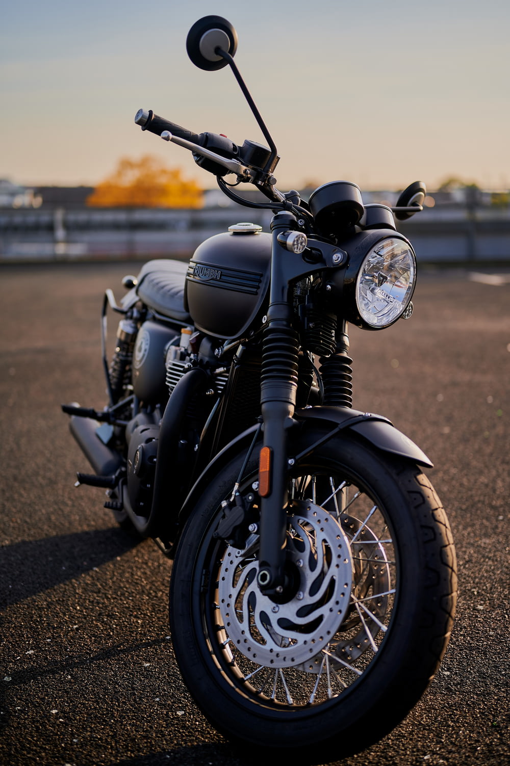 a black motorcycle parked in a parking lot