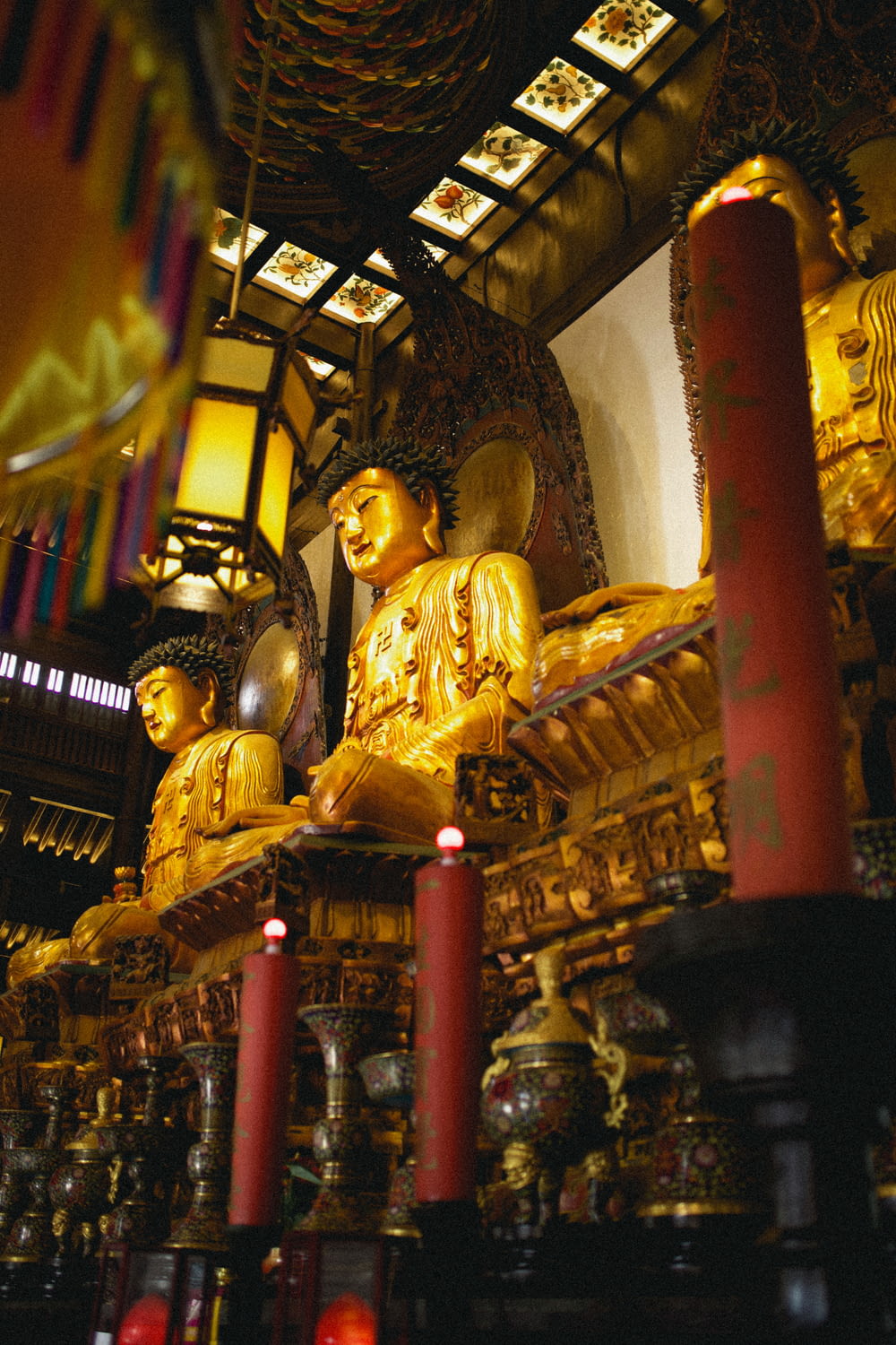 gold buddha statue on brown wooden shelf