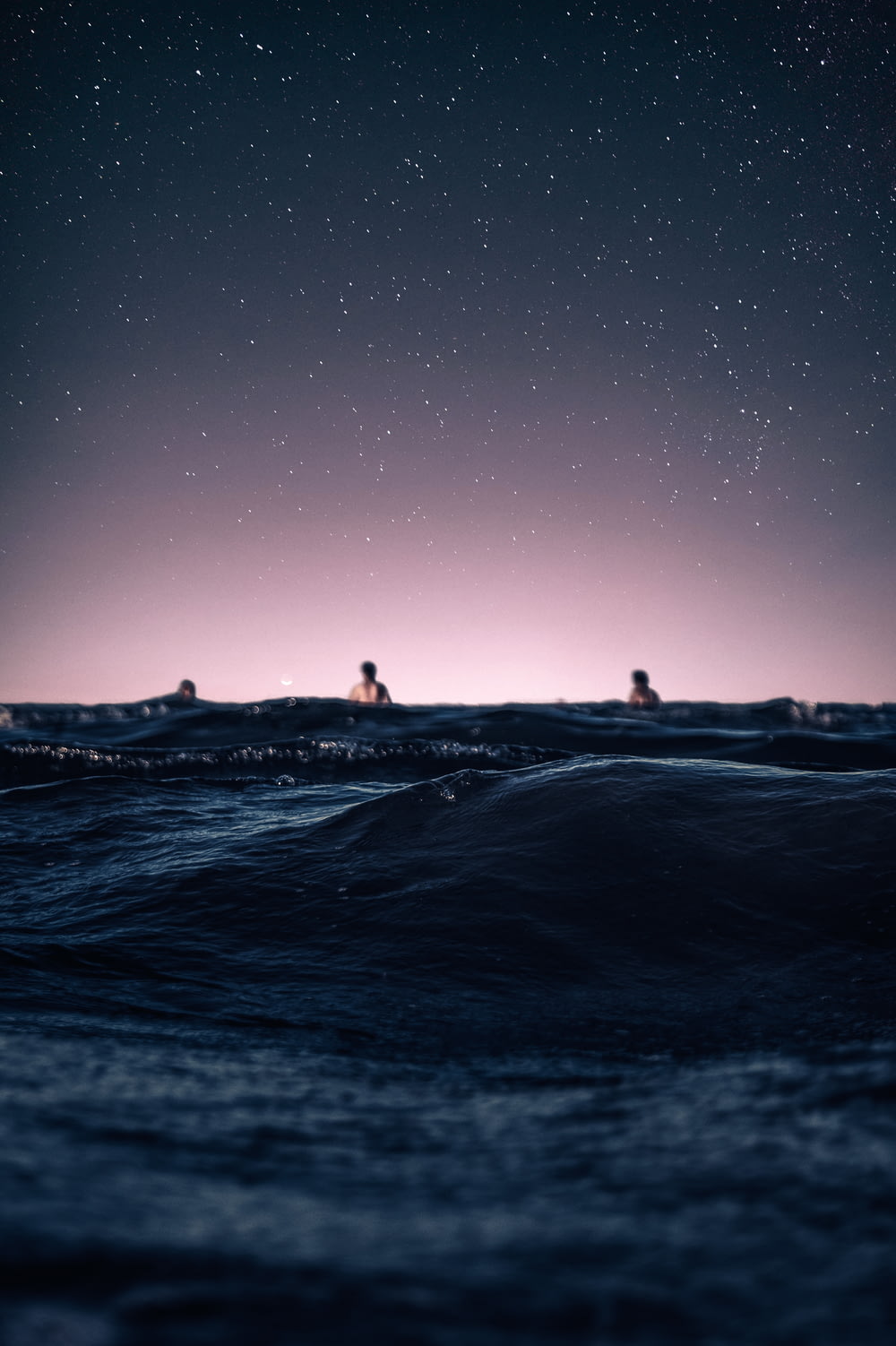 silhouette of people on beach during night time