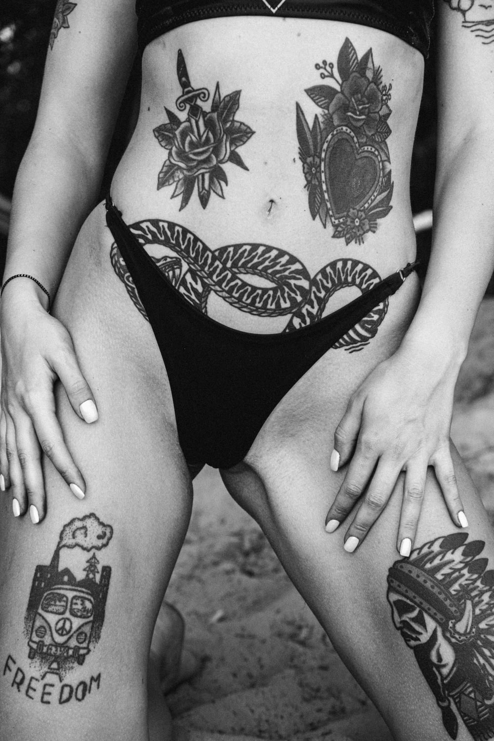 woman in black bikini bottom with tattoo on her back