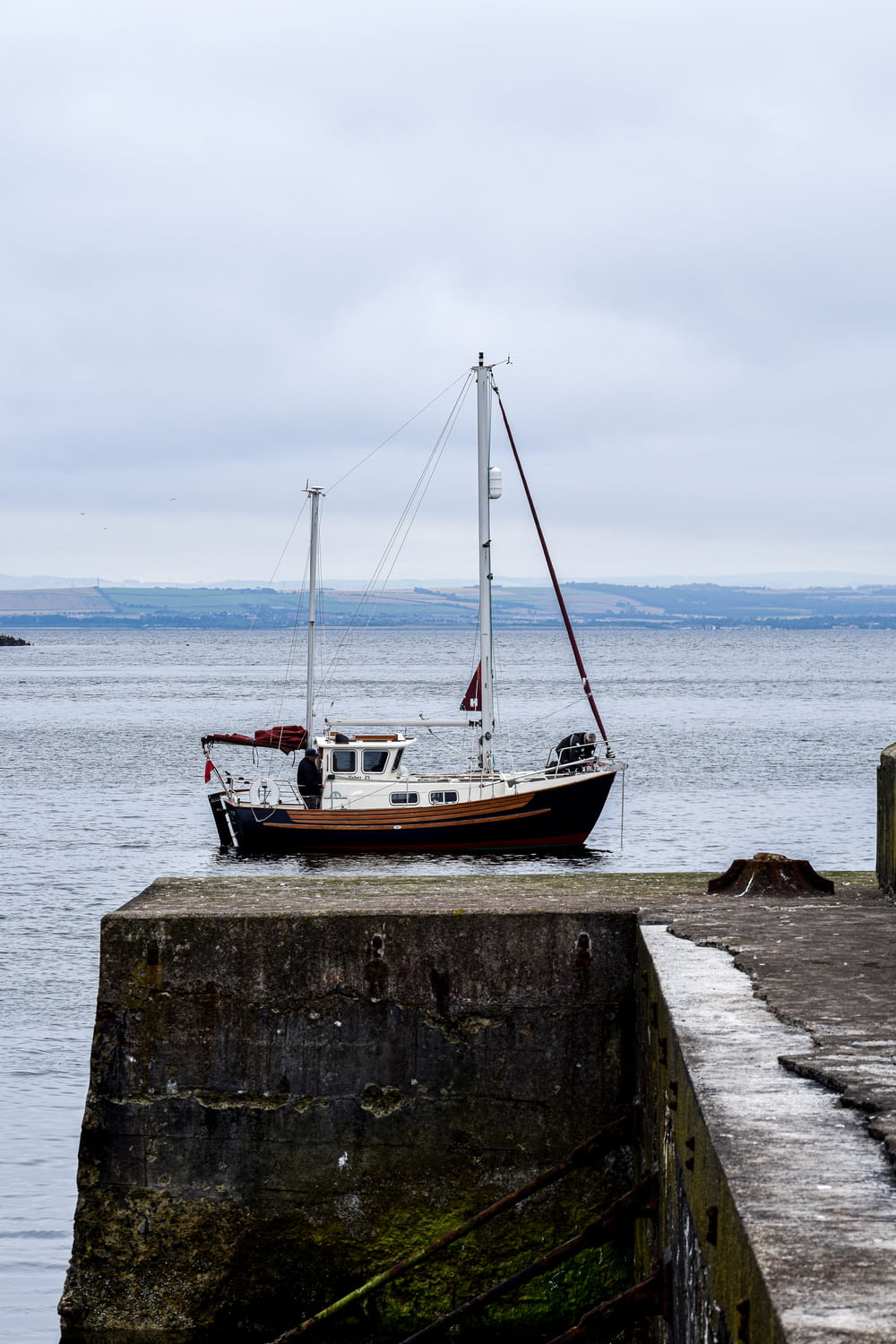 brown and white boat on sea dock during daytime
