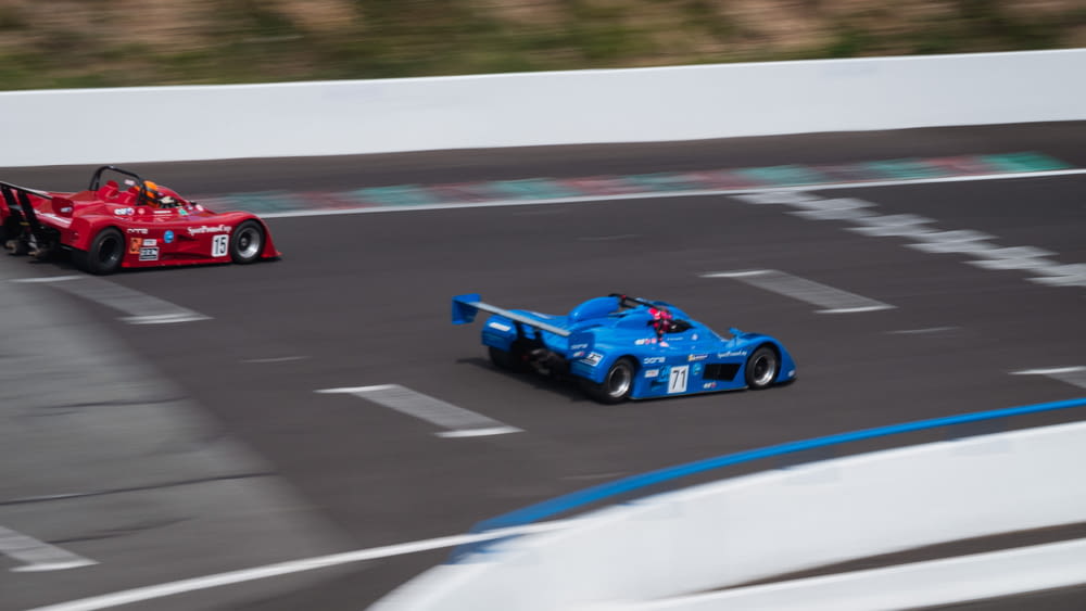 red and blue racing car on track