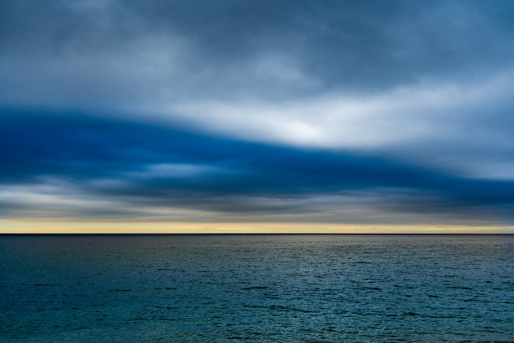 blue sea under blue and white cloudy sky during daytime