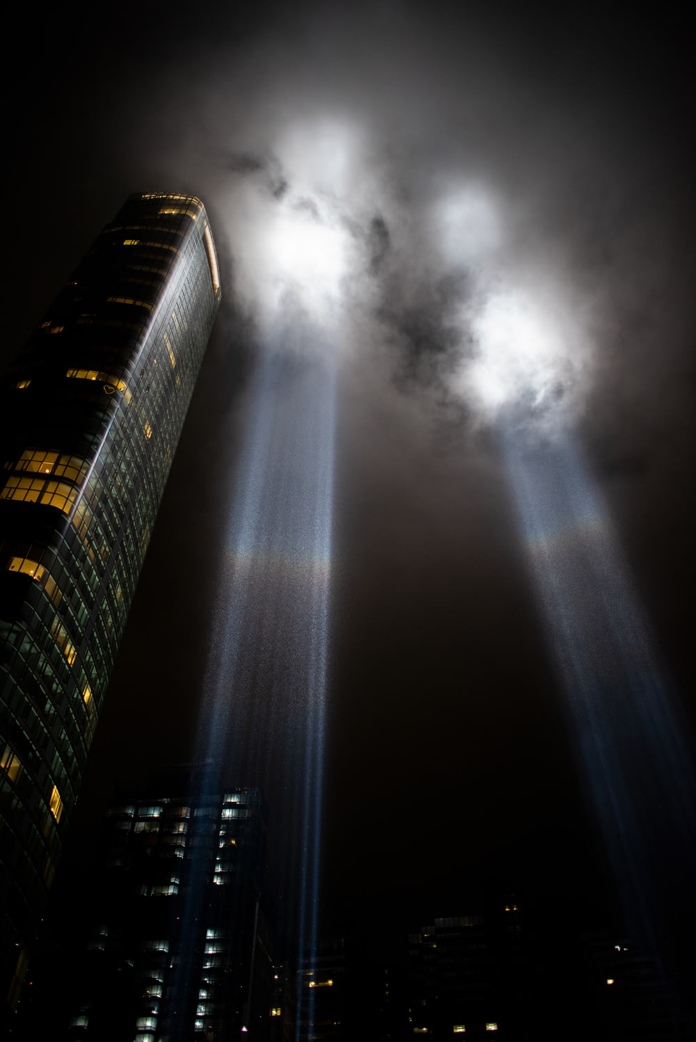 a very tall building with two beams of light coming out of it