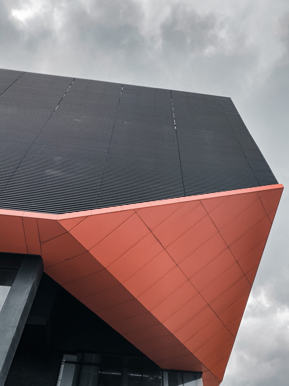 red and black concrete building under white clouds during daytime