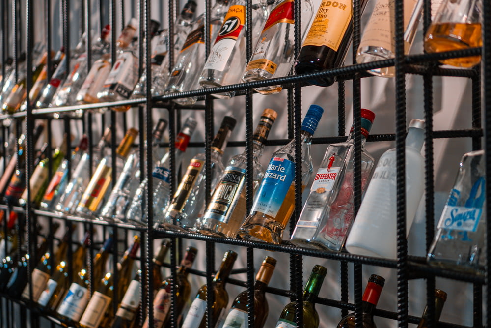 assorted bottles on glass shelf
