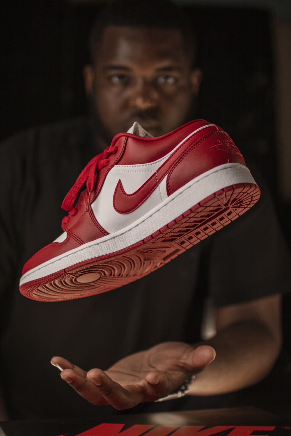 red and white nike athletic shoe