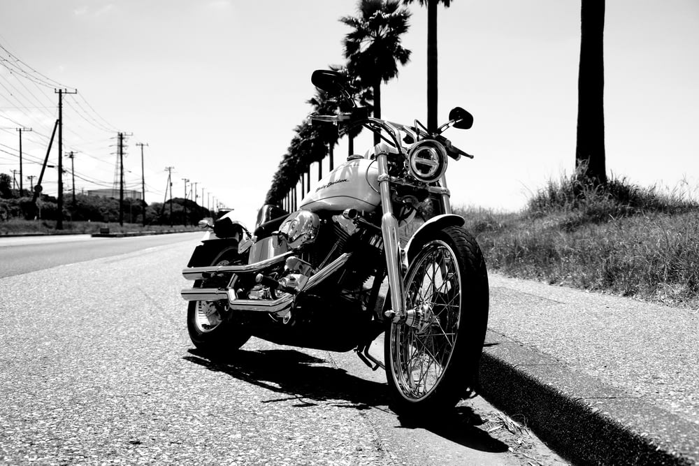 Foto in scala di grigi di una motocicletta parcheggiata sulla strada