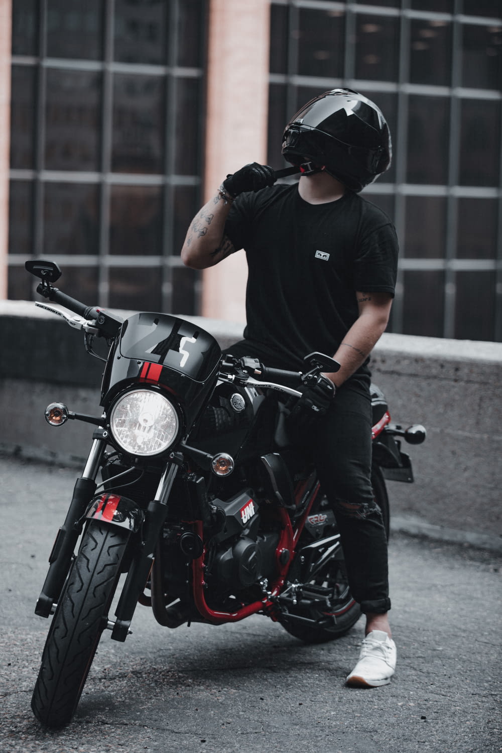 man in black crew neck t-shirt riding black motorcycle during daytime