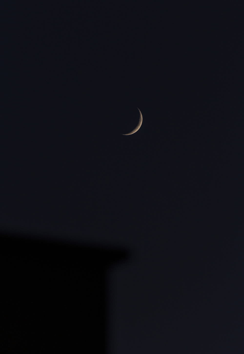 white crescent moon in dark night sky