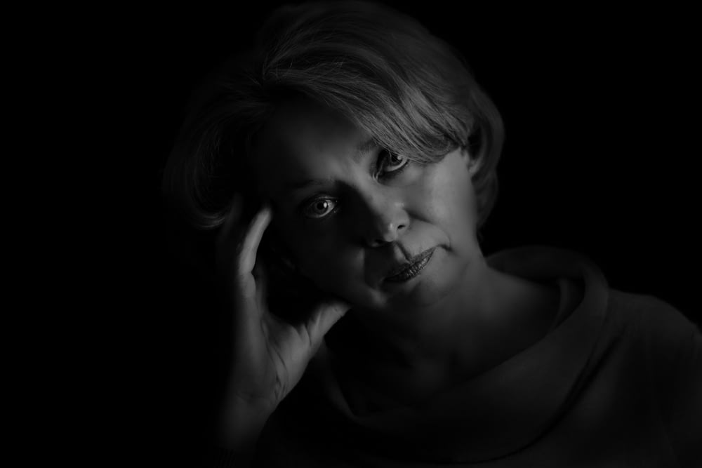 grayscale photo of woman with eyes closed